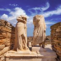 statues of cleopatra and dioscorides amongst archaeological ruins in greece